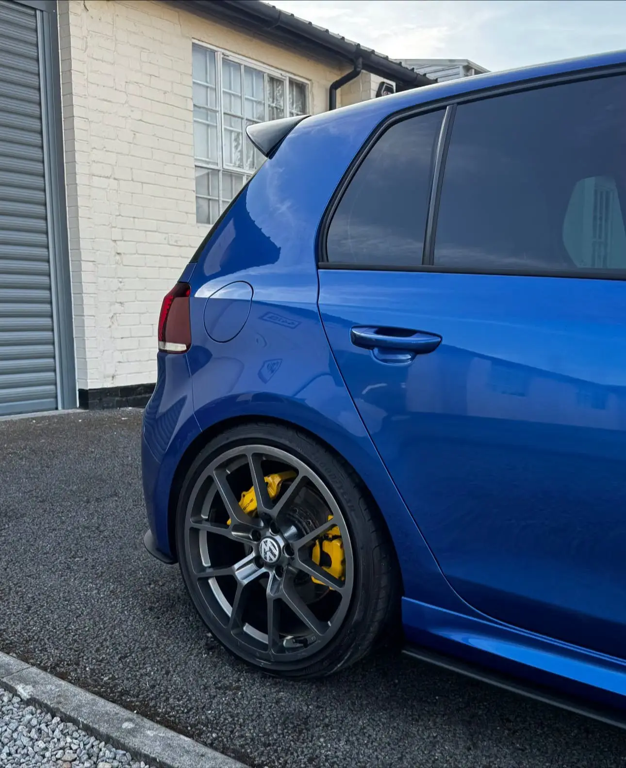 Blue Volkswagen Golf R with yellow calipers